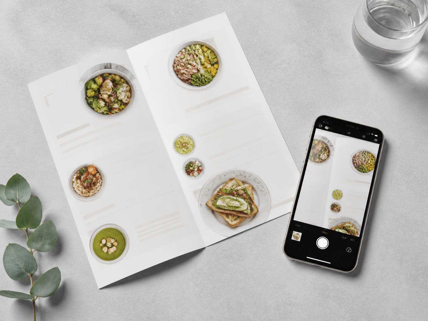 A paper menu being photographed with a phone